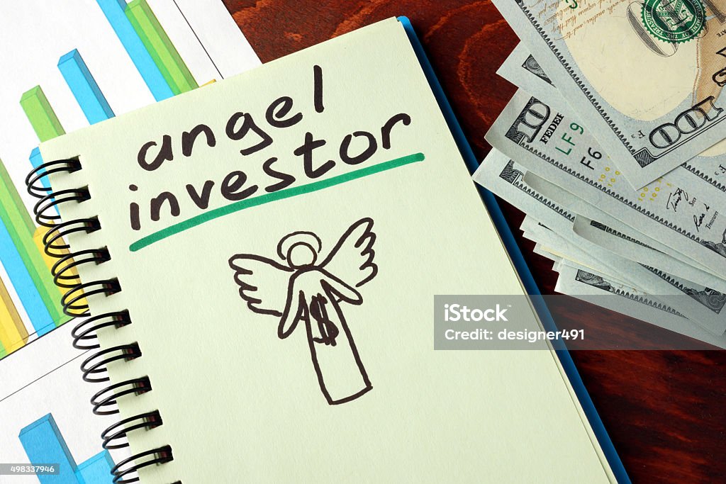 Notebook With Angel Investor Sign. Business Concept.
