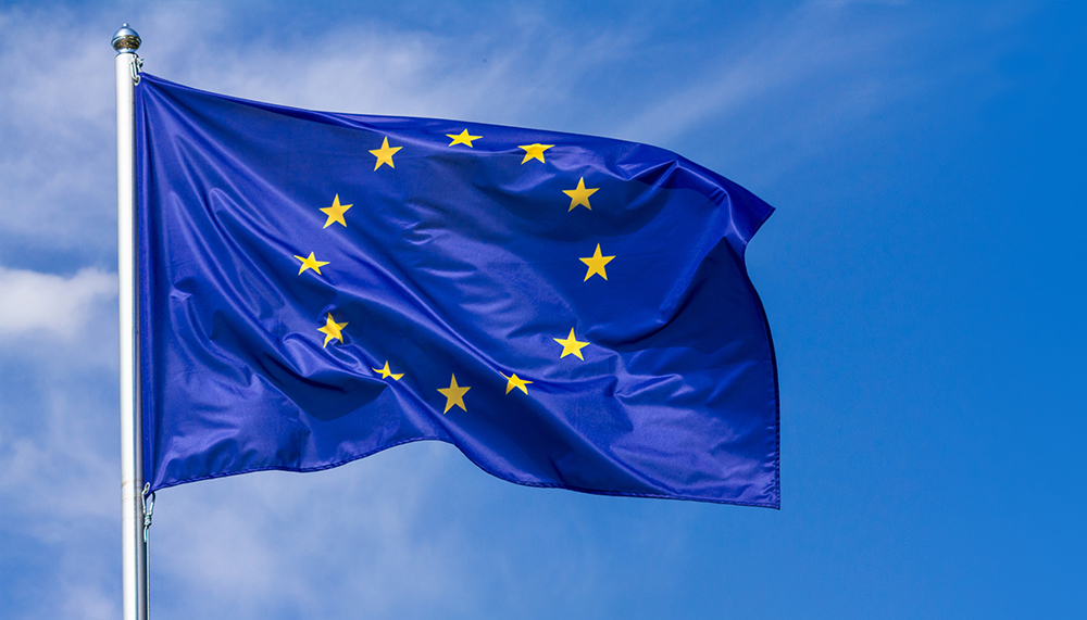 Flag Of The European Union Waving In The Wind On Flagpole Against The Sky With Clouds, Banner
